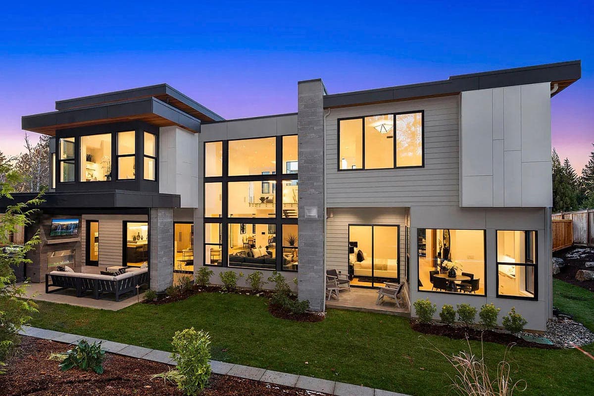 Modern house plan exterior with two stories, flat rooflines, large windows, and cantilevered sections.