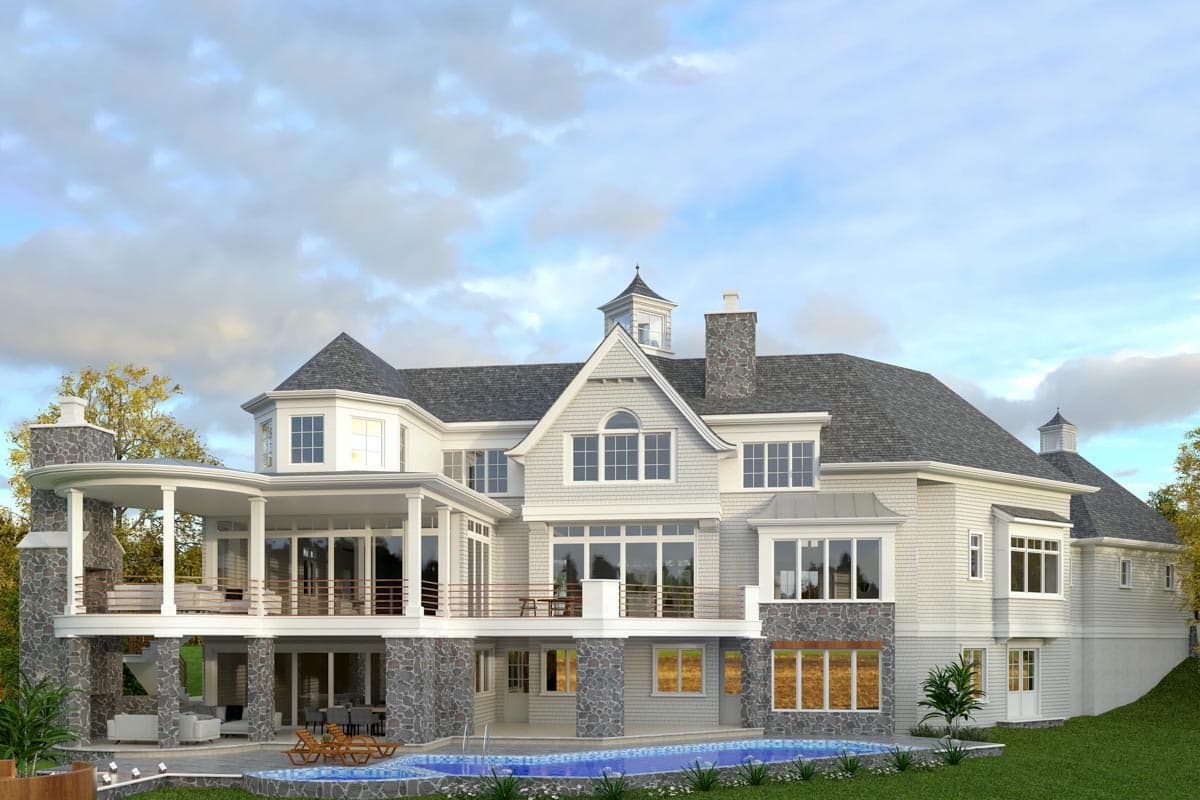 House plan exterior view of a large, multi-story home with a curved porch, stone accents, multiple gables, and a cupola.