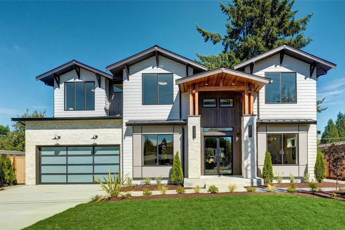House plan exterior with modern style, two stories, gable roof, covered entry, and attached garage with glass panels.