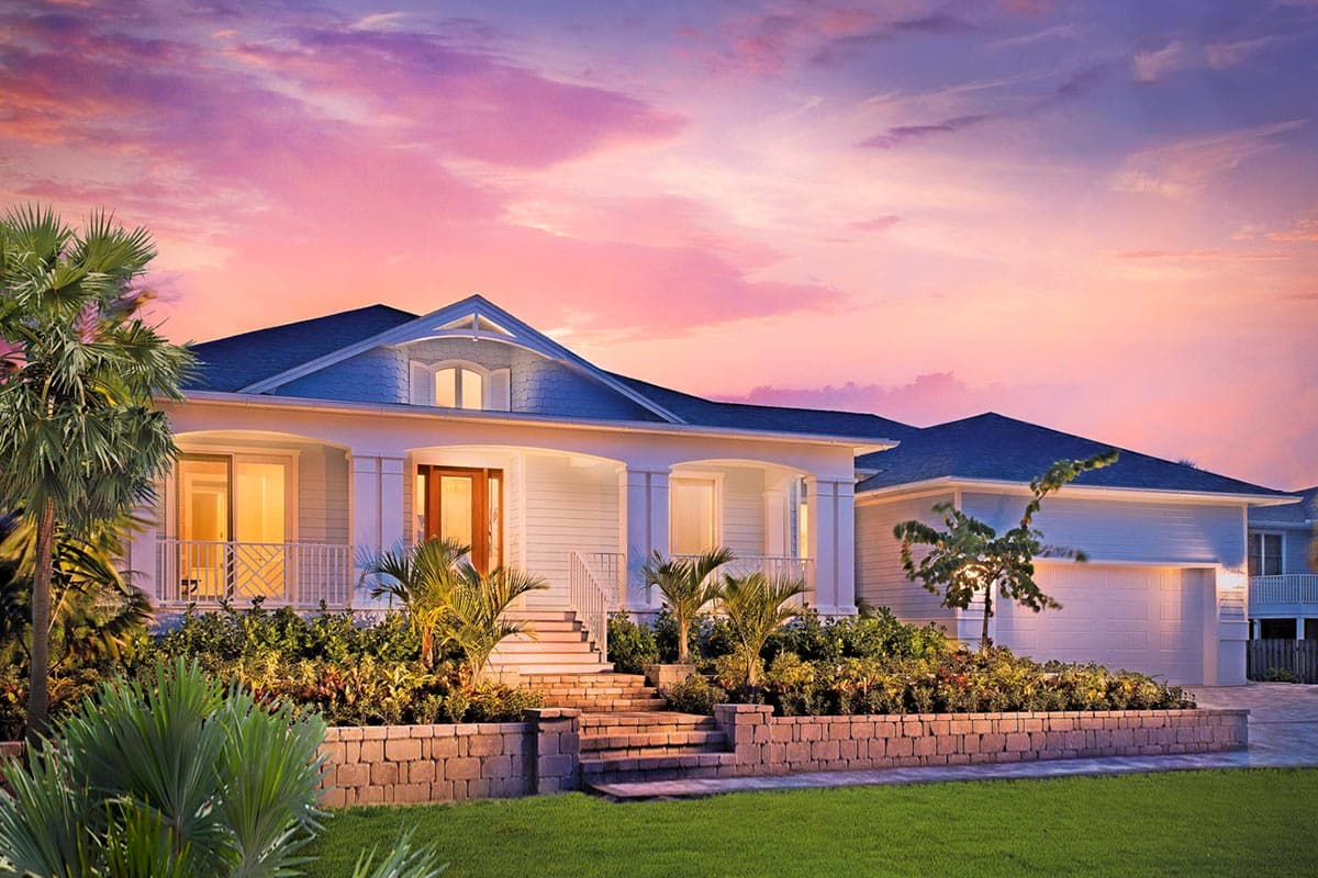 House plan exterior. Two-story home with a porch supported by columns. Features include gabled roof, dormer, and attached garage with a two-car bay.