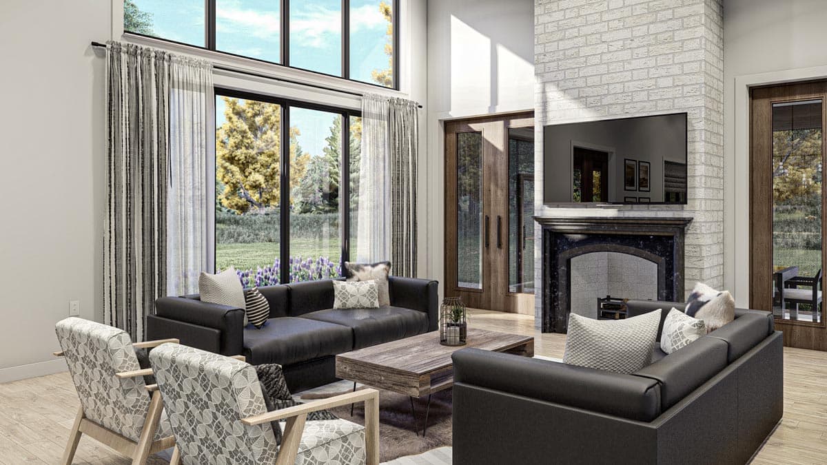 Modern living room with a large fireplace, sectional sofa, patterned chairs, and floor-to-ceiling windows.