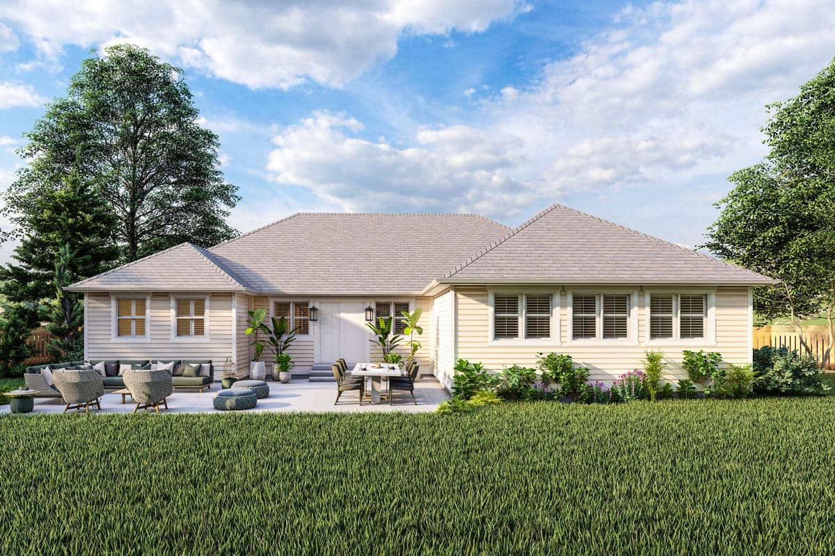 One-story house plan exterior with light siding, hipped rooflines, multiple gabled dormers, and a patio with outdoor seating and dining.