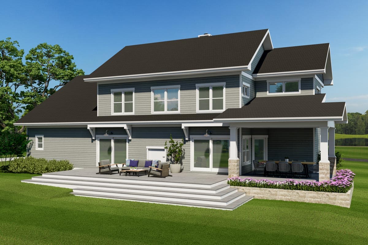 House plan exterior: Two-story home with multiple gables, expansive deck, and covered porch with seating.