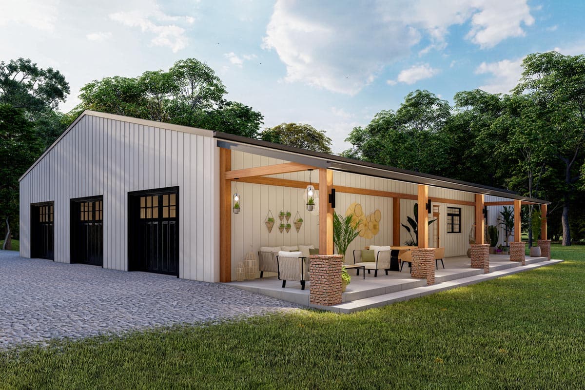 Modern white building with black garage doors, featuring a covered patio with seating, wooden beams, and decorative elements; lush green yard.