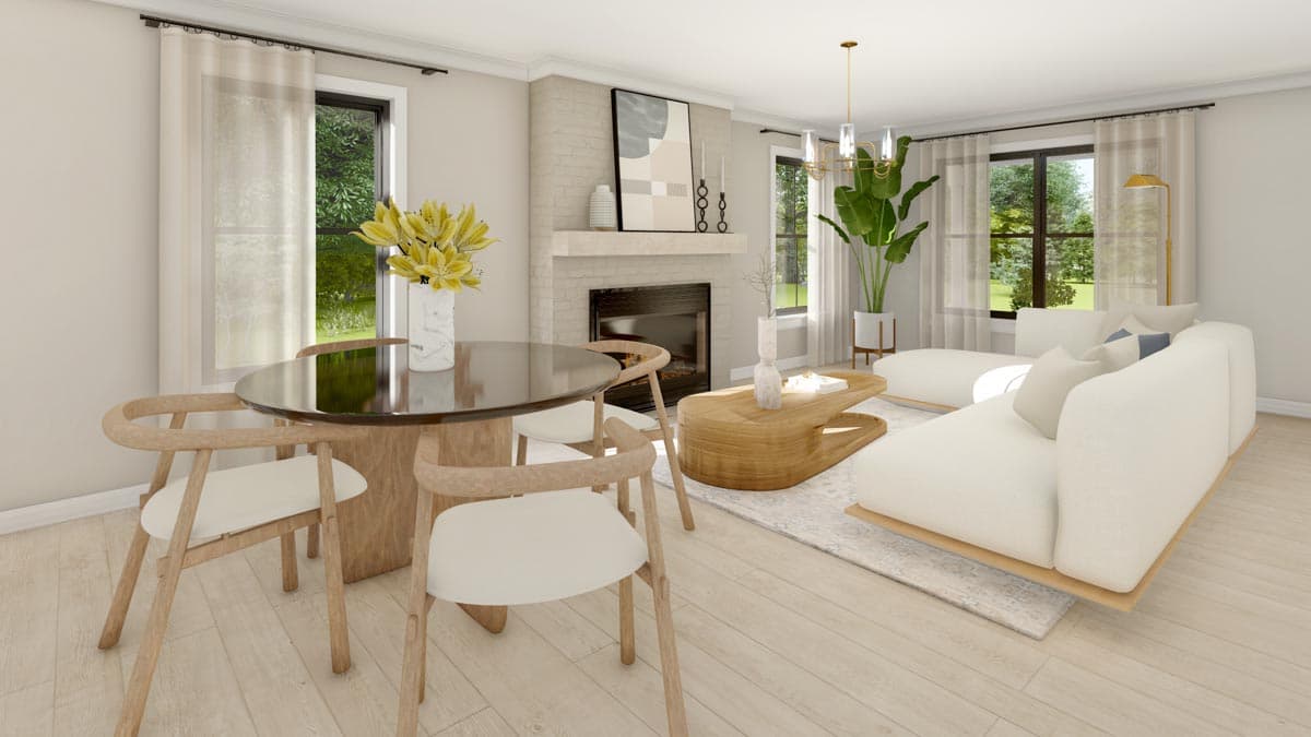 Dining area with round table and chairs next to fireplace and sectional sofa in living room.