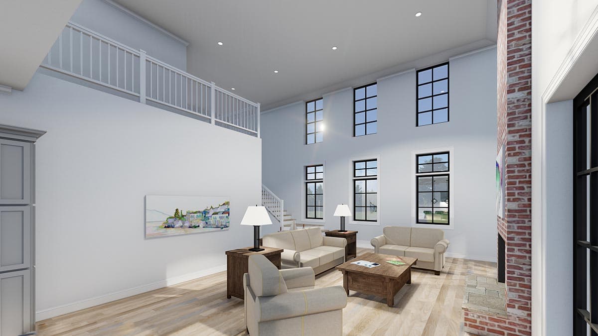 Interior view of open great room with vaulted ceiling, fireplace, staircase, and loft overlooking the space.