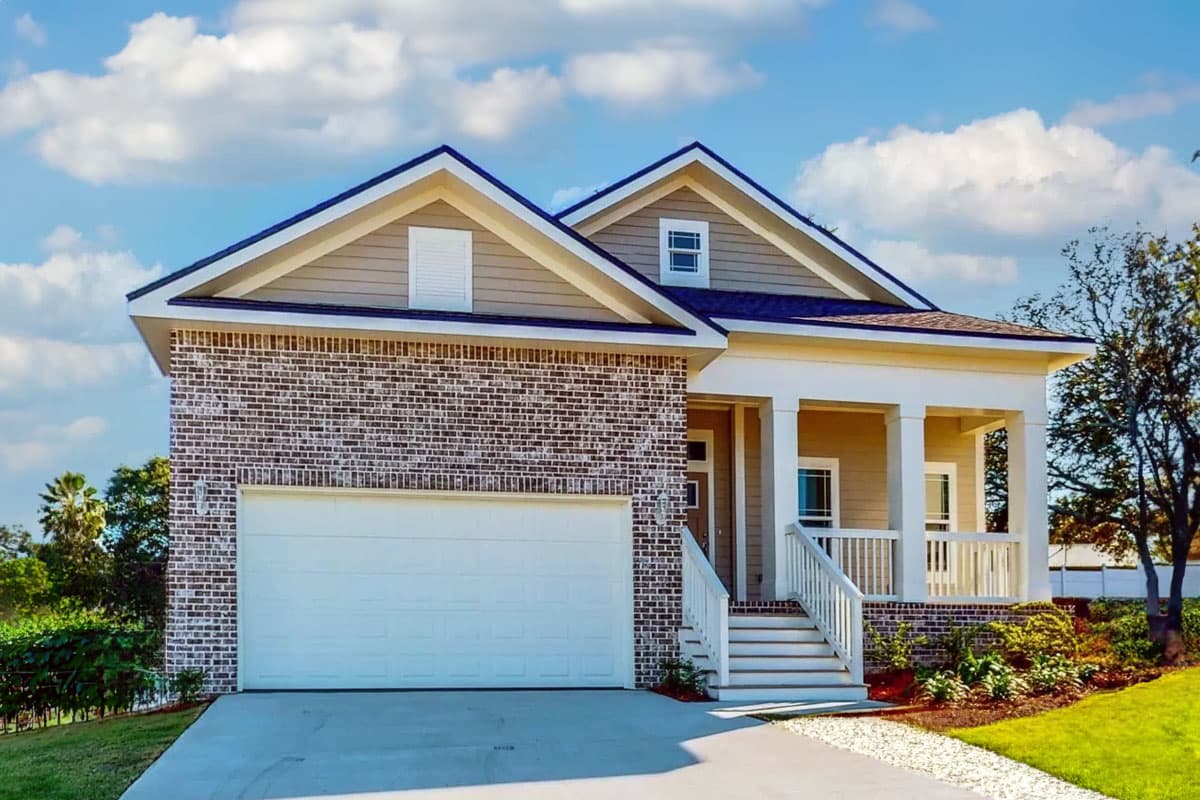 House plan exterior: Two-story Modern Farmhouse with brick lower half, vinyl siding, gabled roof, dormer window, and covered front porch.