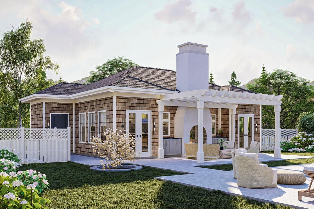 House plan exterior with cedar shake siding, white-trimmed windows, french doors, and an outdoor fireplace with pergola.