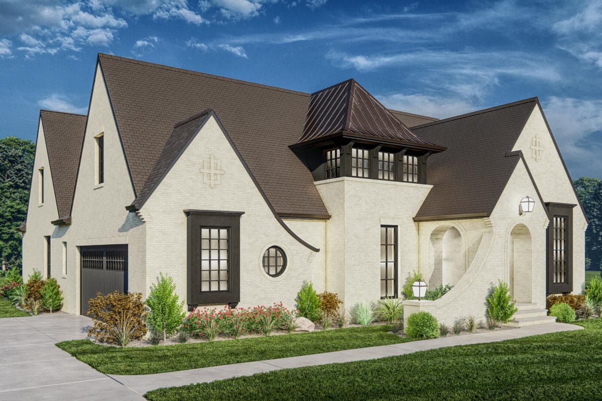 House plan exterior: Two-story Tudor style with brick facade, prominent gables, arched entryway, and multi-window dormer.