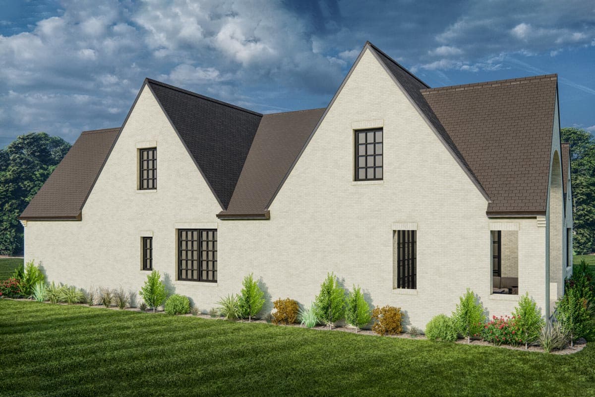 House plan exterior: Two-story dwelling with light brick facade, prominent gables, and multi-pane windows.
