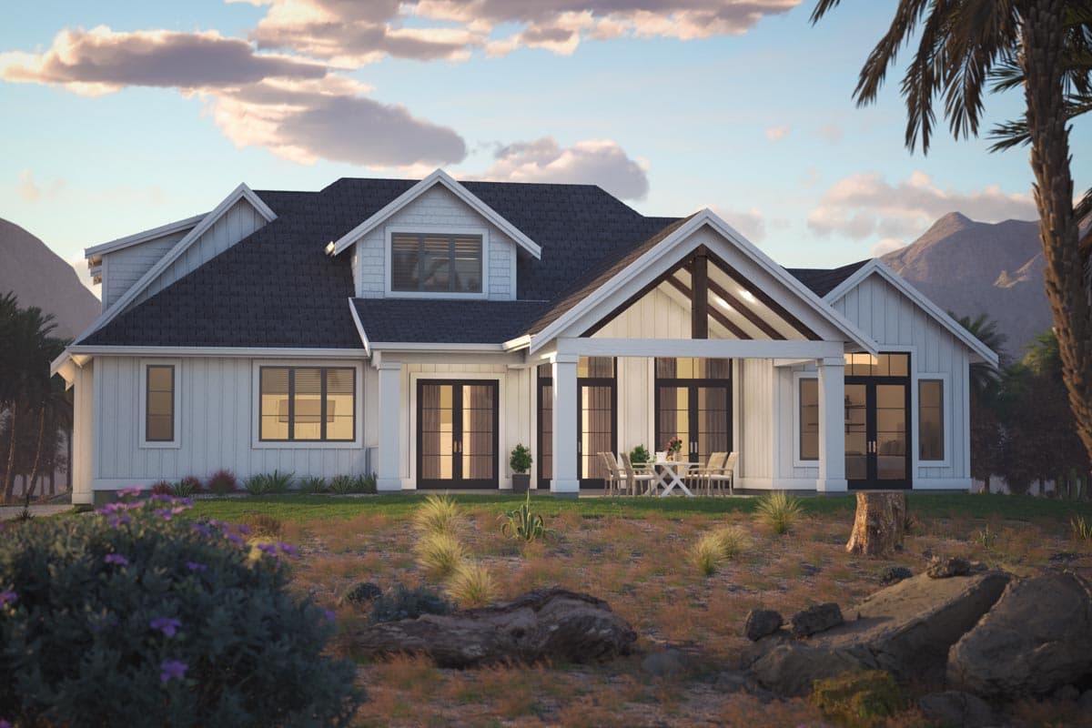 Modern Farmhouse house plan exterior with multiple gables, covered porch with exposed beams, and double doors.