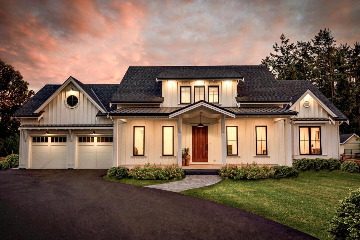 House plan exterior. Two-story Modern Farmhouse with gabled roof, dormers, and attached garage. Includes a porch and a circular window detail.