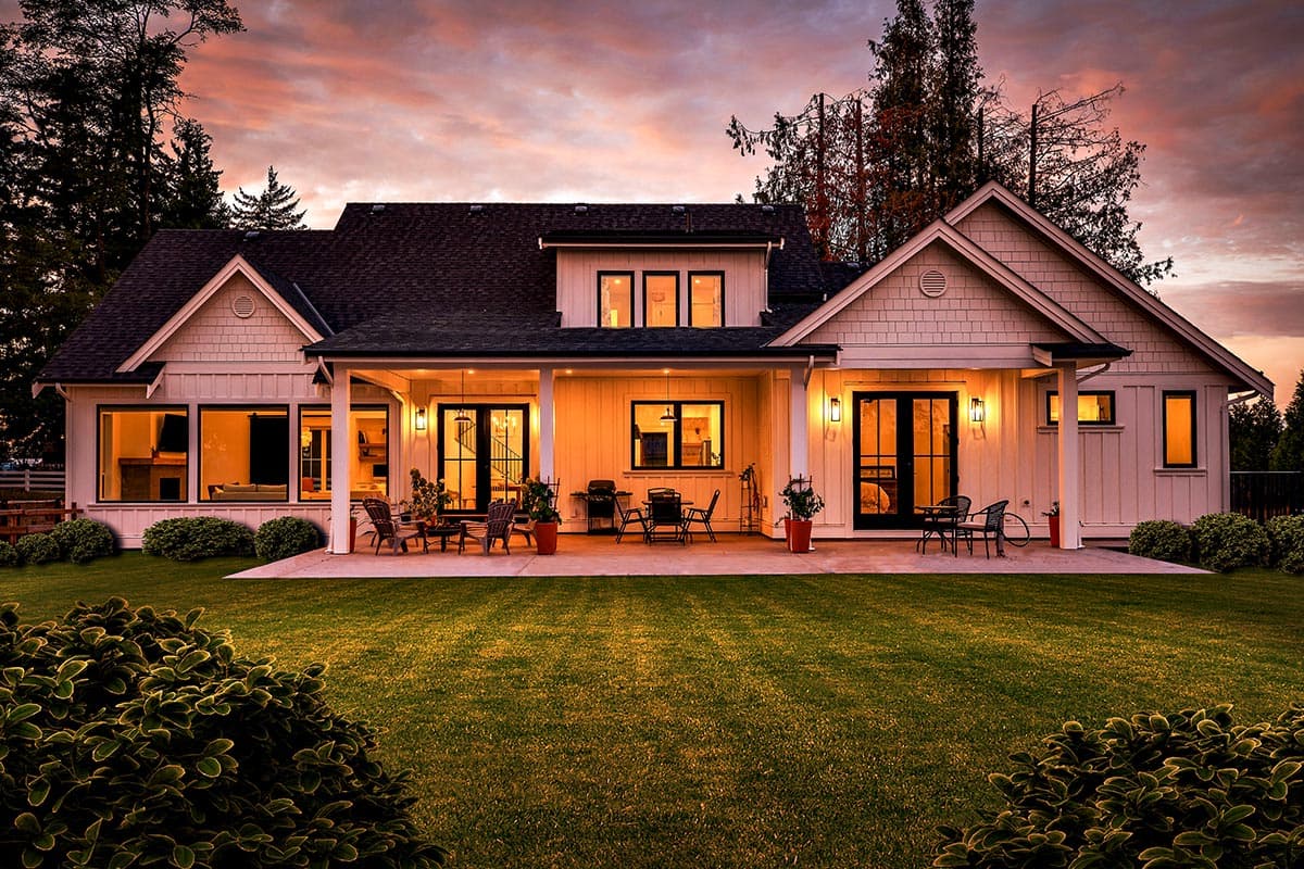 Modern Farmhouse house plan exterior with covered porch, multiple gables, board and batten siding, and large windows.