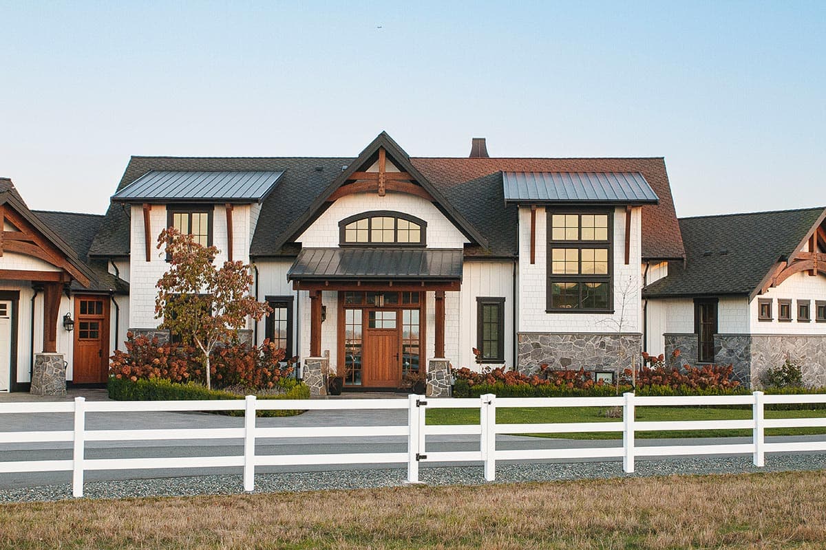 Modern Farmhouse house plan exterior with multiple gables, wood beams, stone accents, and metal rooflines.