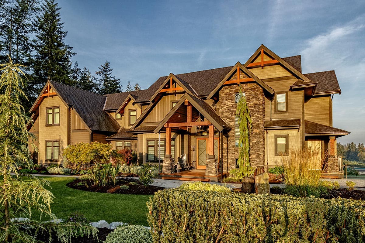 House plan exterior featuring Craftsman-style architecture, multiple gables, a covered porch, and a combination of wood siding and stone cladding.