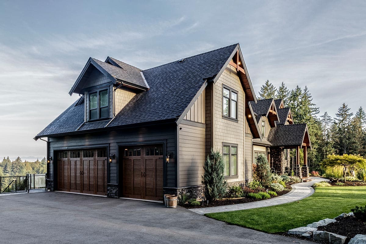 Craftsman style house plan exterior with three-car garage, dormer, and multiple gables.