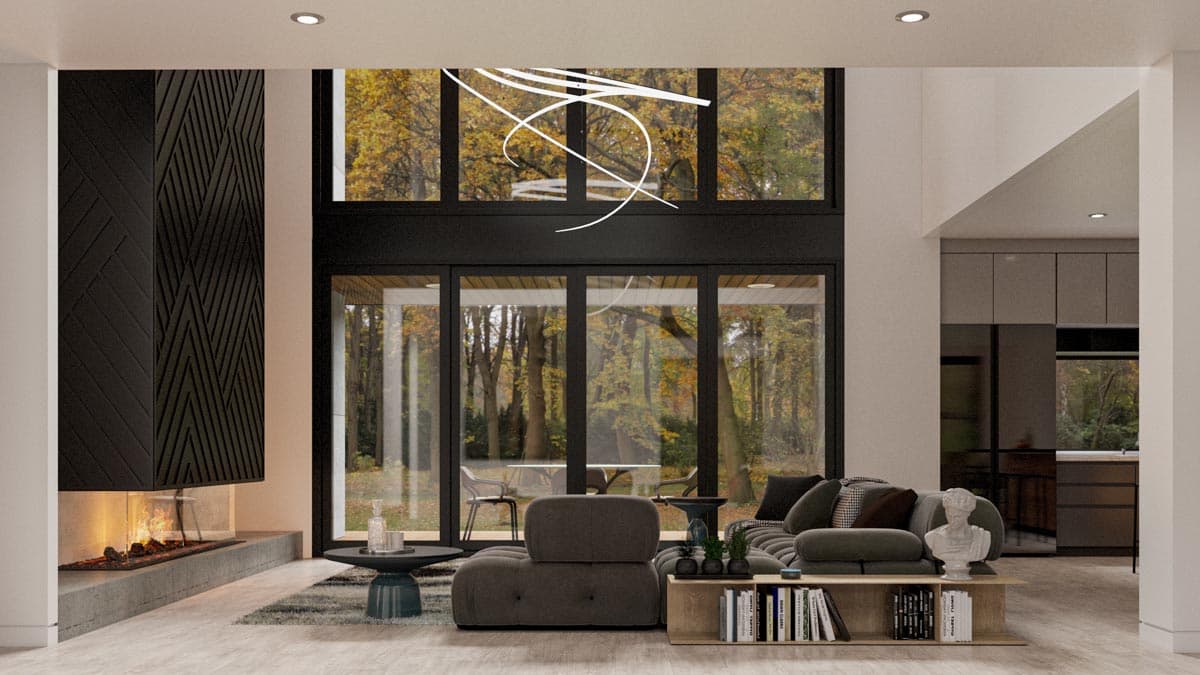 Modern living room with fireplace, large windows overlooking trees, sectional sofa, and open kitchen.