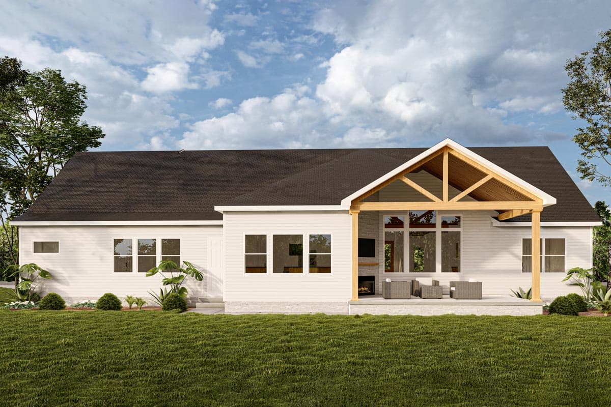House plan exterior: Single-story home with a large covered patio featuring exposed wood beams, stone fireplace, and large windows.