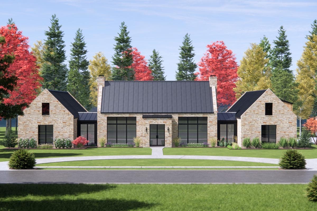 House plan exterior with stone veneer facade, a dark metal roof, gables, and several large windows with black trim.