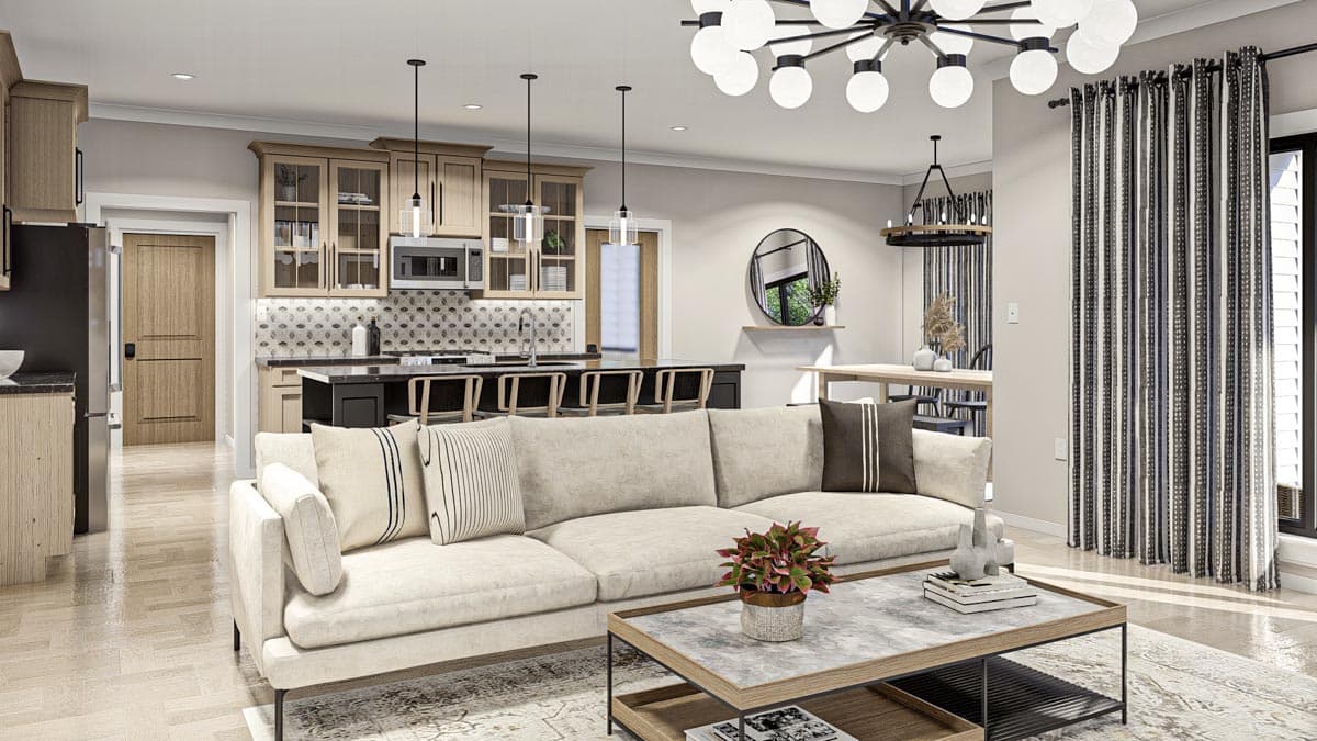 Open-concept living area with neutral sofa, kitchen island with bar seating, and contemporary lighting.
