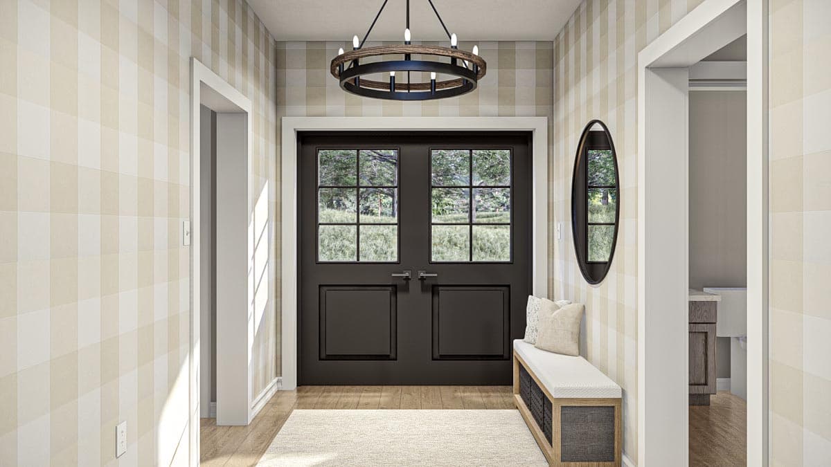 Interior view of entryway with double doors, bench, and rustic chandelier. House plan.