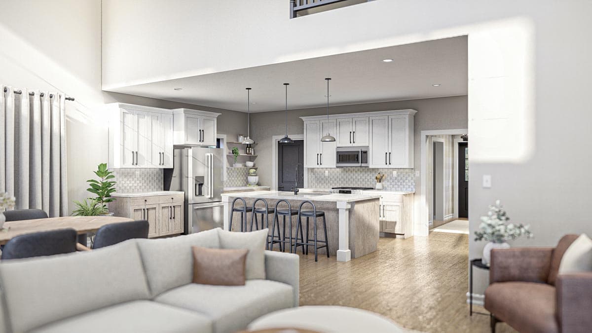 Open-concept kitchen with white cabinets, a large island with seating, and a stainless steel refrigerator.
