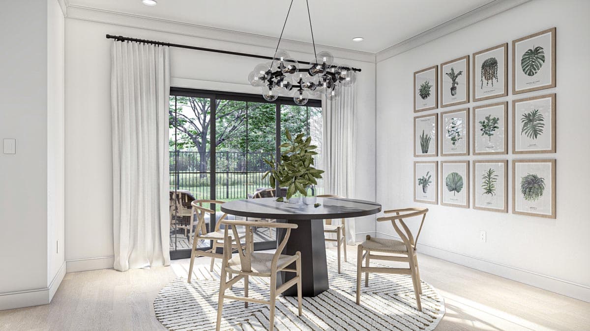 Dining room with round table, wishbone chairs, gallery wall of botanical prints, and large sliding glass doors.