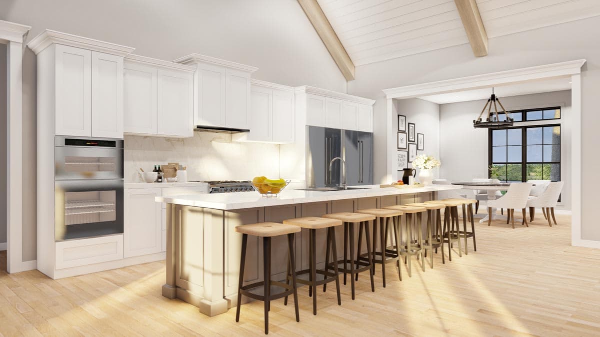 Kitchen and dining area with vaulted ceiling, wood beams, large island with seating, and pendant lights.