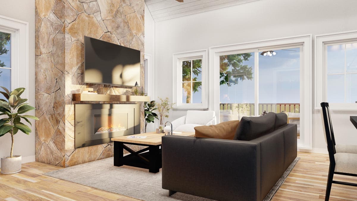 Living room with floor-to-ceiling stone fireplace, mounted television, and large windows. Modern furniture arrangement.