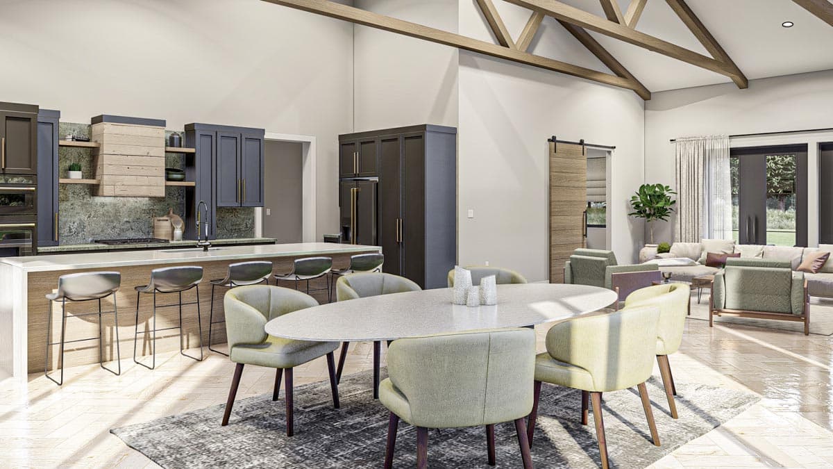 Open concept living space with vaulted ceilings, exposed beams, modern kitchen island, dining area, and living room.