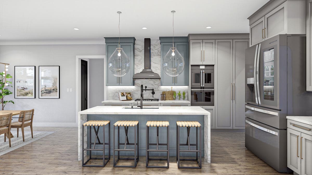 Modern kitchen with island, pendant lights, dual ovens, and stainless-steel refrigerator. Adjacent dining area visible.