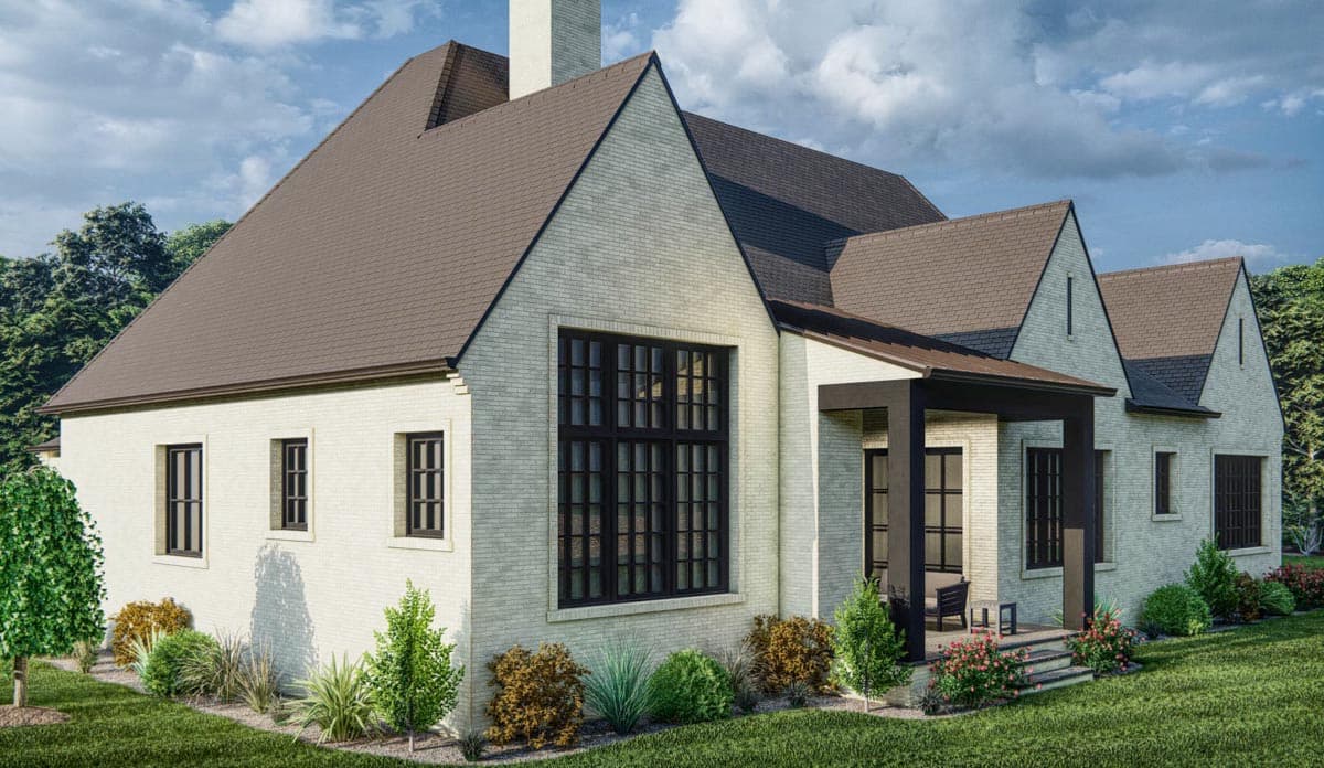 House plan exterior: Light brick, gable rooflines, large grid windows, and covered porch.