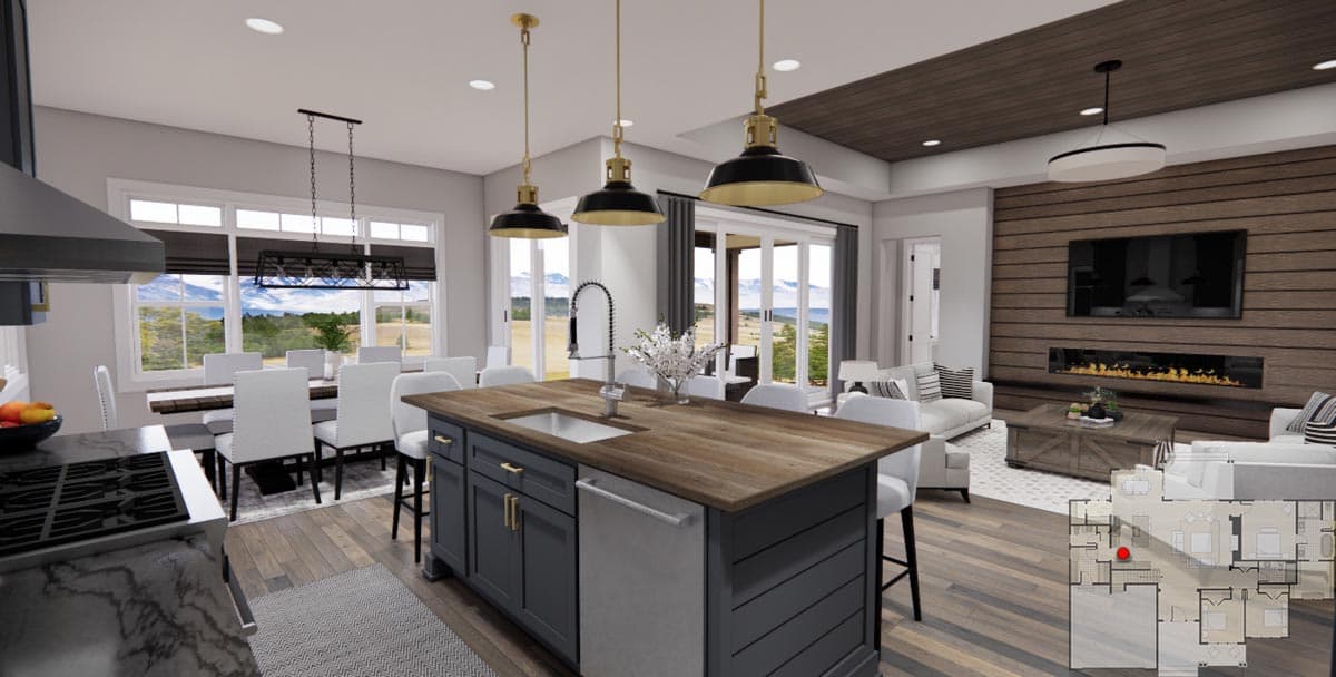 Open-concept living area with kitchen island, dining area, and living room featuring a fireplace and wood accent wall.