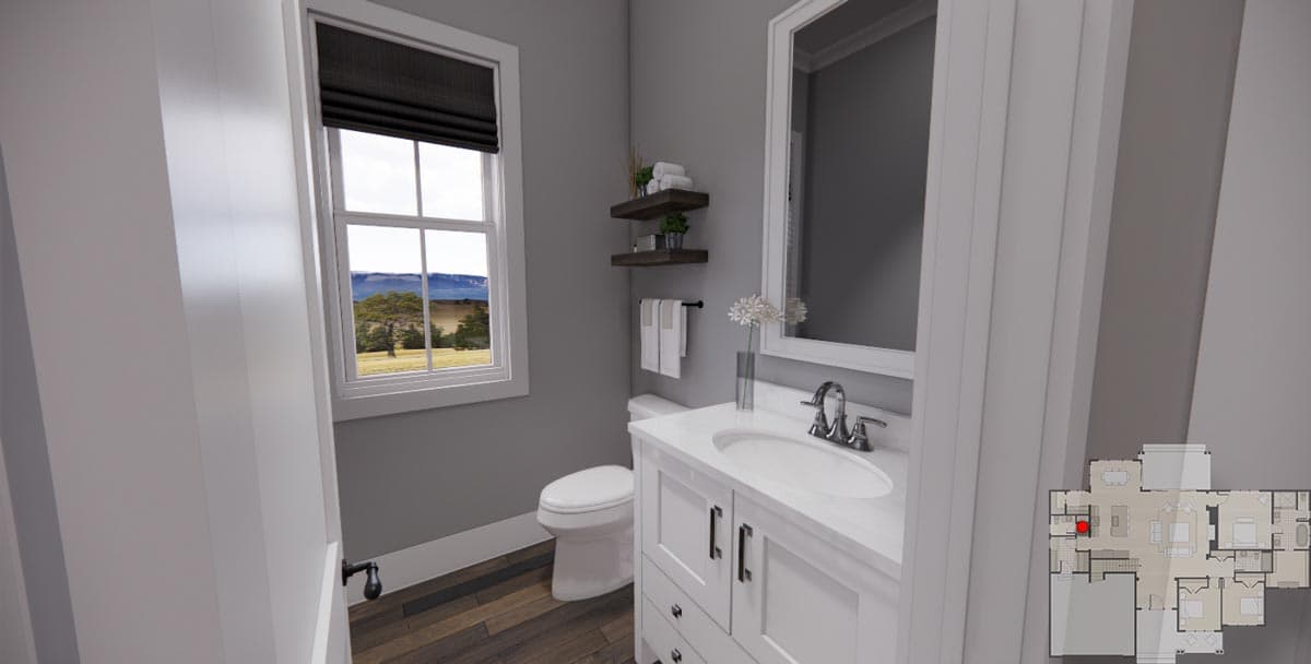 Powder room with toilet, vanity, and window overlooking landscape. Floor plan indicates location.
