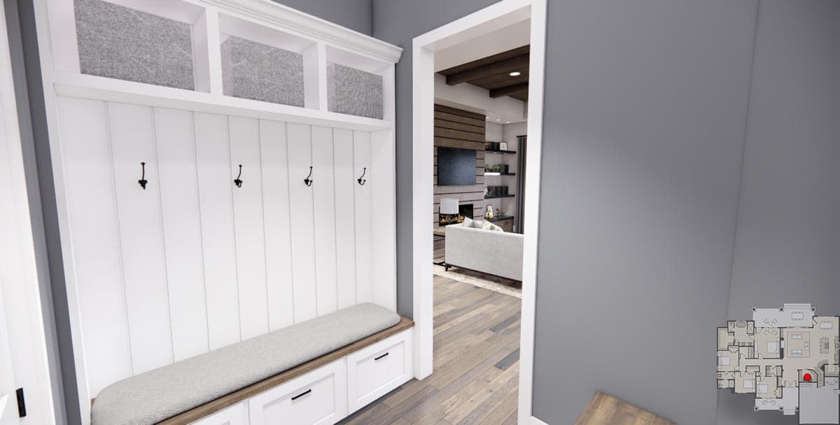 Interior view of a mudroom with paneled walls, bench seating, storage cubbies, and a doorway to a living area with fireplace.
