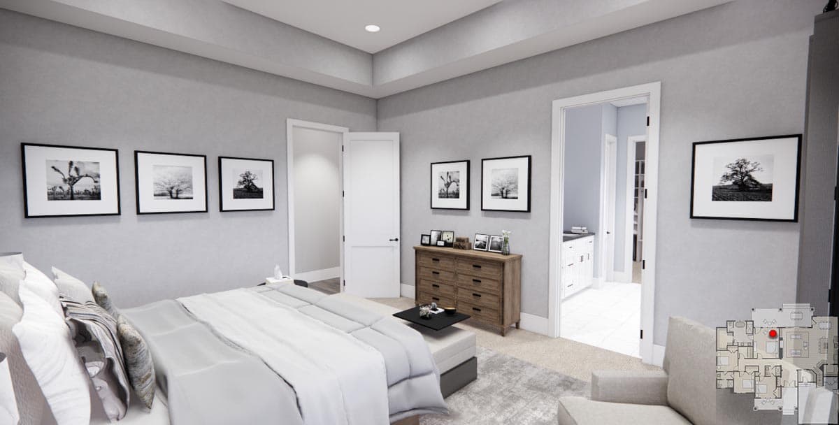 Primary bedroom with tray ceiling, dresser, and artwork. Opens to hallway and en-suite bath.