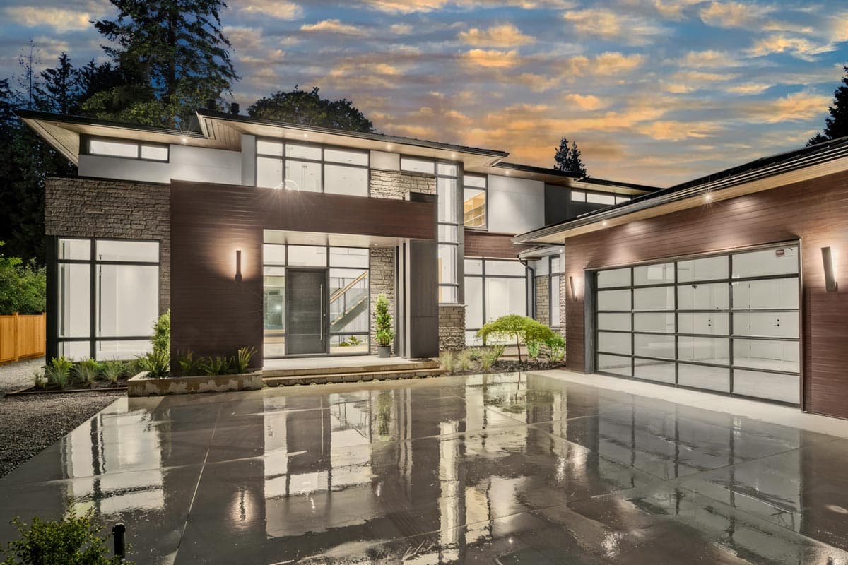 Modern house plan exterior with stone and wood facade, flat roofline, large windows, and glass garage door.