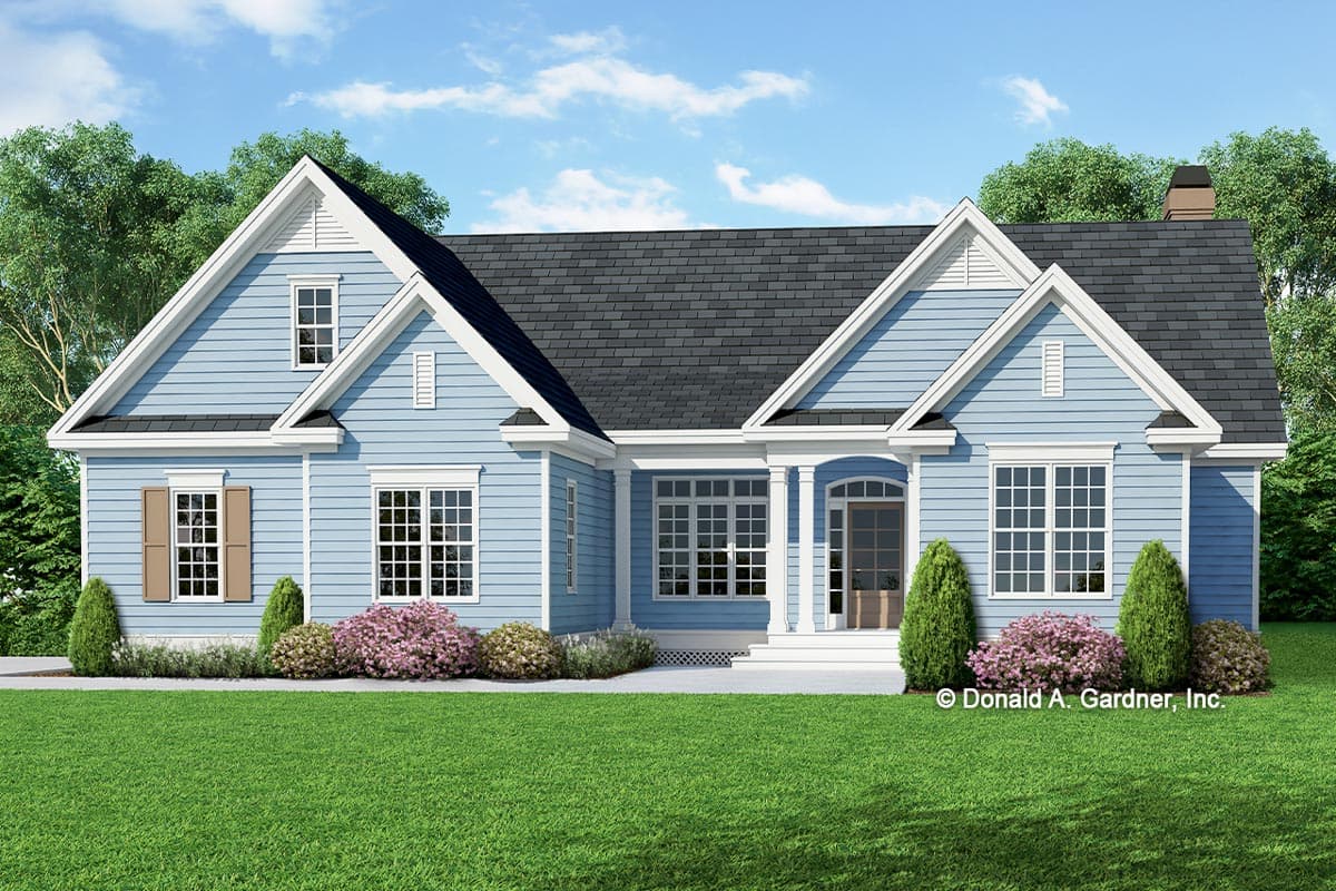 House plan exterior. Two-story house in a Cottage style with gable rooflines, multiple windows, and a front porch supported by columns.