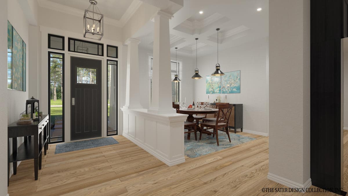 Interior view of a house plan showing a dining area with a table and chairs, adjacent to an entryway with a dark door and sidelight windows.