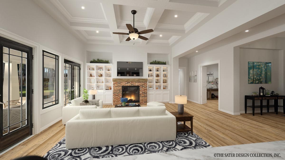 Living room with coffered ceiling, fireplace, built-in shelving, and large glass doors.