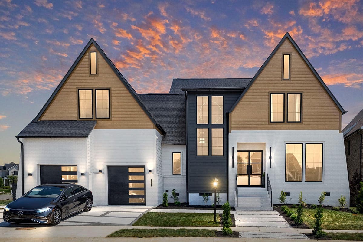 House plan exterior with modern farmhouse style. Two-story home with gabled roof, dormers, and attached garage. Featuring brick and wood siding.