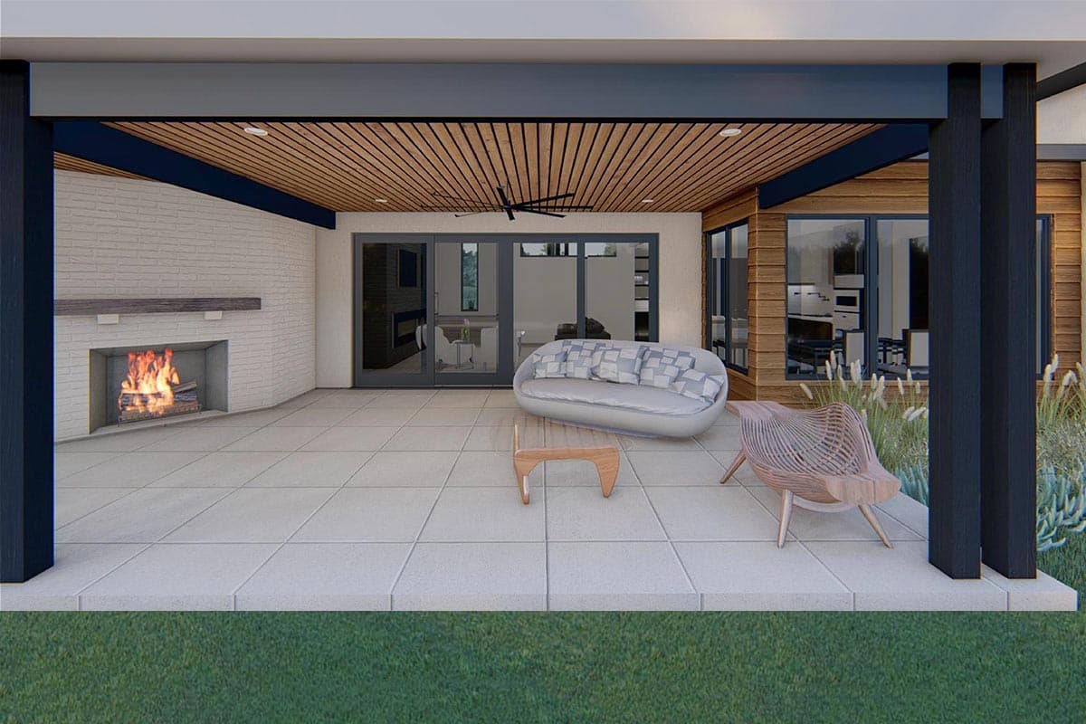Covered patio with outdoor fireplace, wood-slat ceiling, and large glass doors opening to an interior.