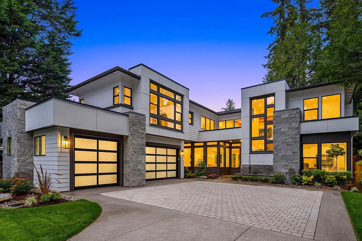 House plan exterior with modern design. Two-story structure featuring a flat roof, stone accents, and glass garage doors. Large windows are prominent.