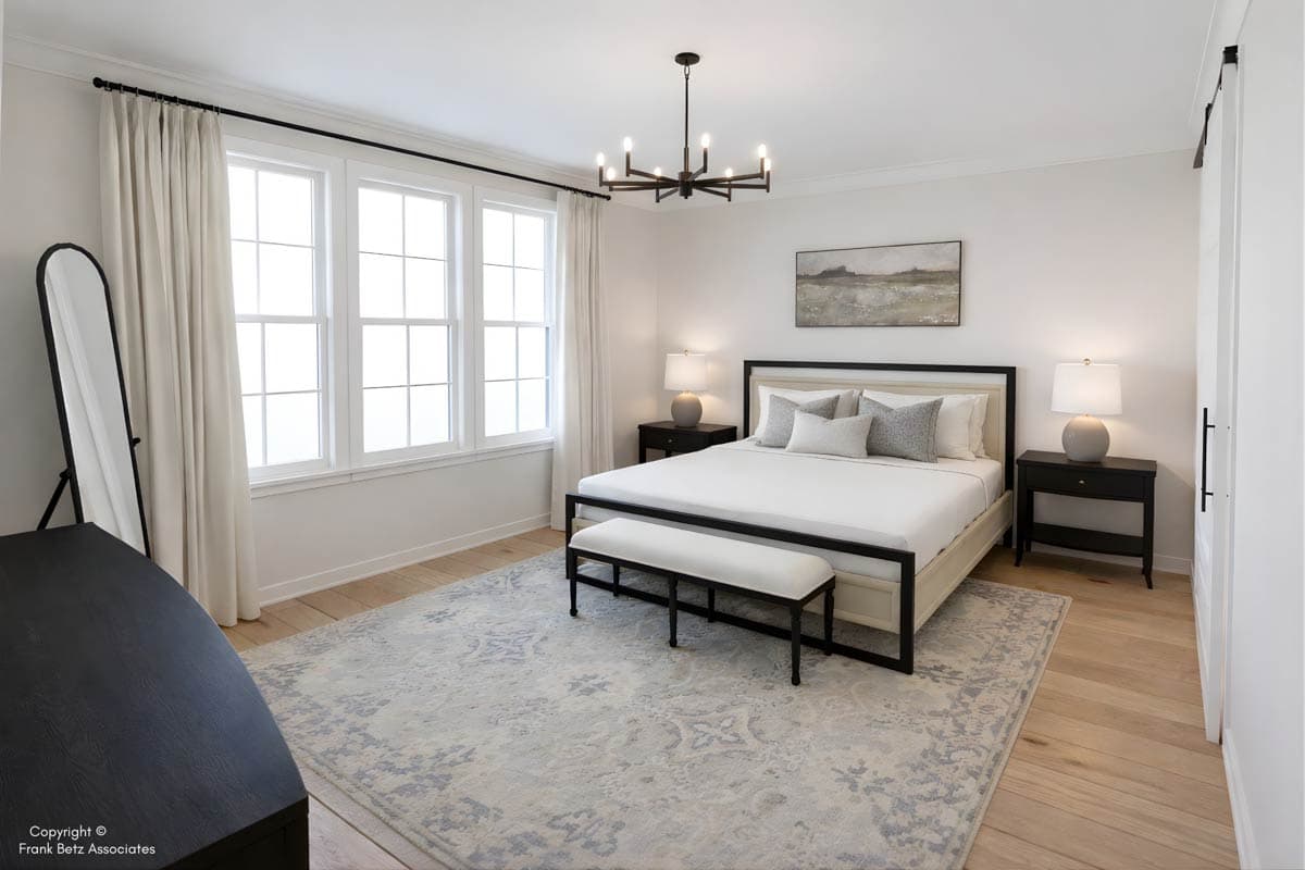 Primary bedroom with king bed, triple windows, bench at foot of bed, contemporary chandelier, and sliding barn door.
