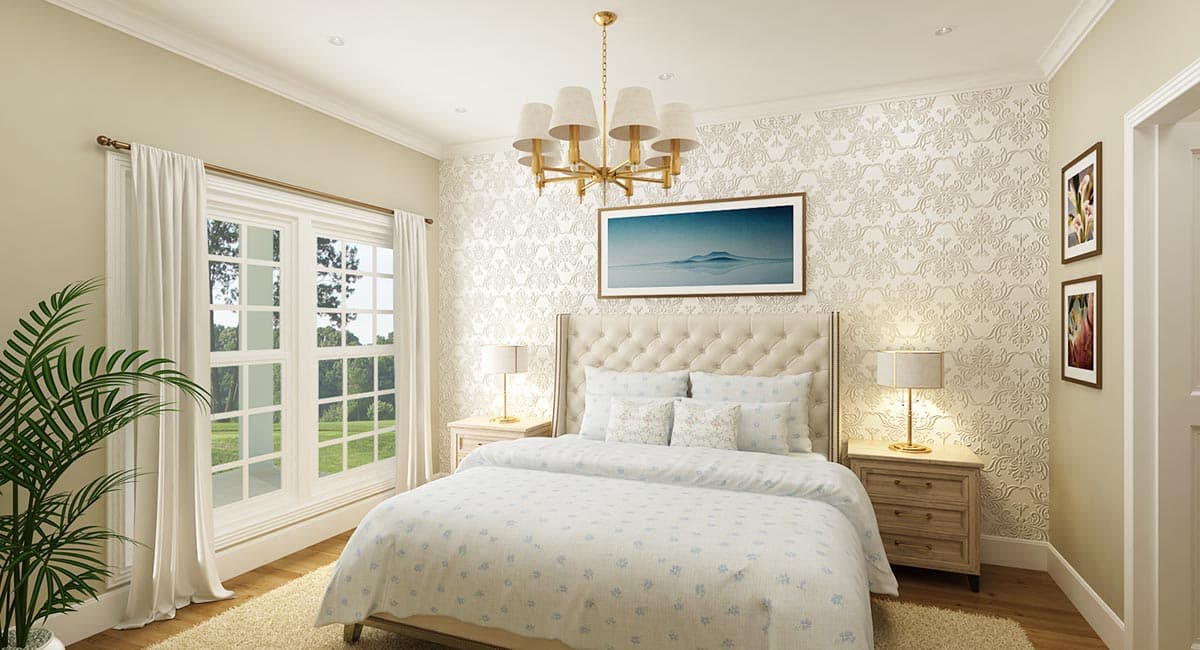 Bedroom interior with tufted headboard, patterned wallpaper, a large window with white curtains, and a gold chandelier.