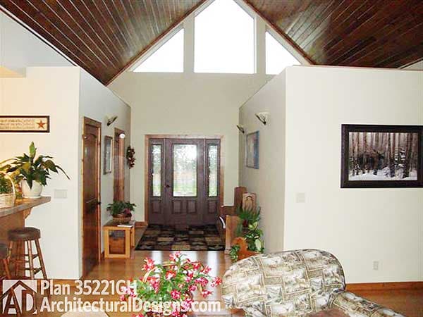 Interior view of house plan 35221GH, showing vaulted wood ceiling, double entry doors, and entryway.