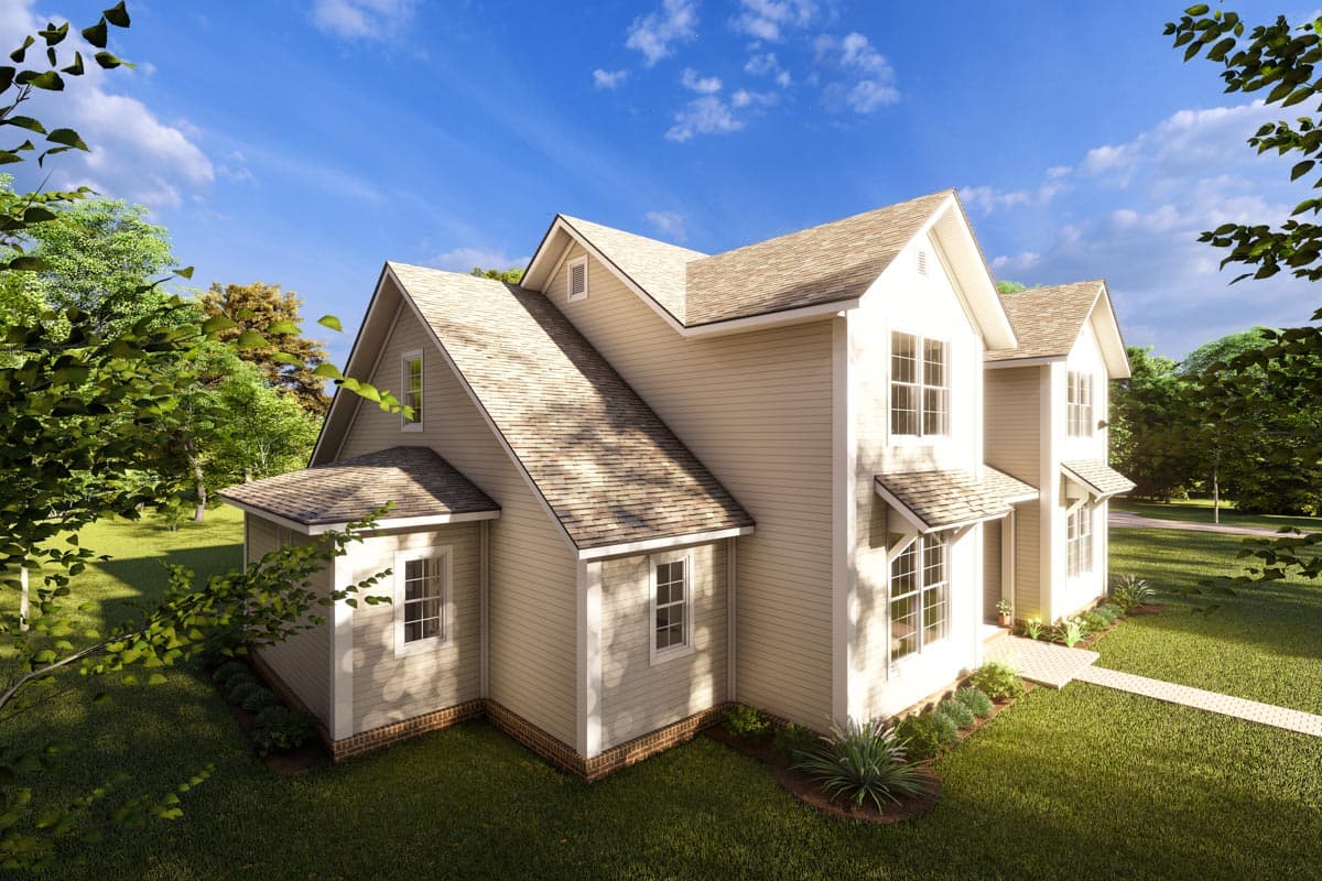 House plan exterior with gabled rooflines, multiple dormers, and varied window styles, set in a grassy yard.