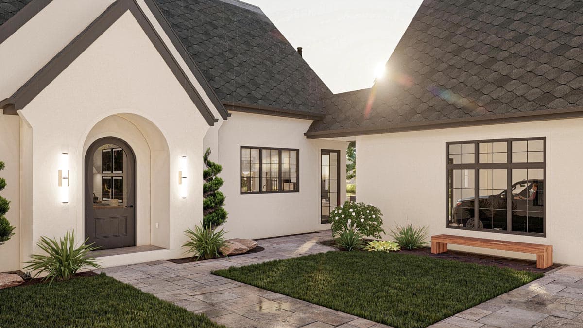 House plan exterior with stucco finish, arched entryway, dark roof, and dark-framed windows.