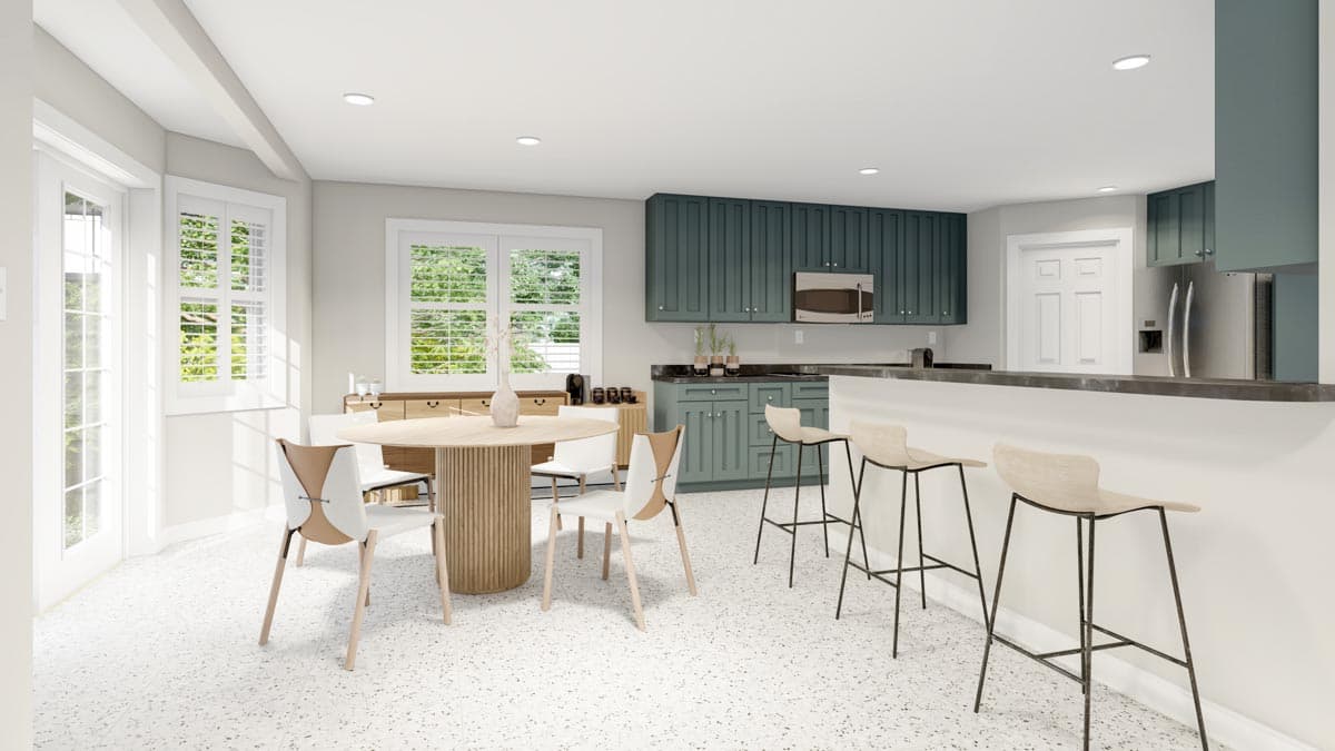 Kitchen and dining area with island seating, teal cabinetry, round dining table, and French doors.