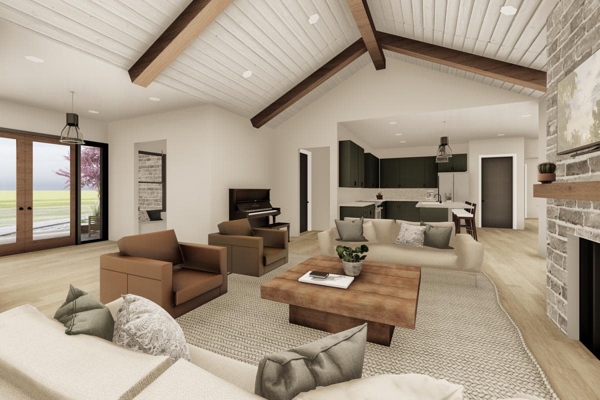 Great room with vaulted beamed ceiling, kitchen, fireplace, and French doors to exterior.